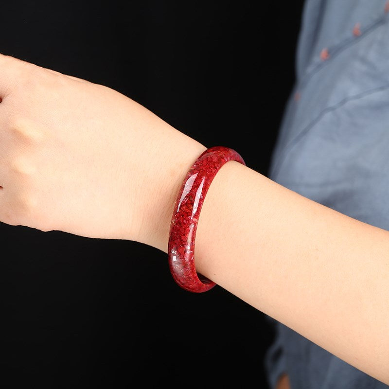 Red cinnabar mineral crystal-sand bangle showing granular internal texture
