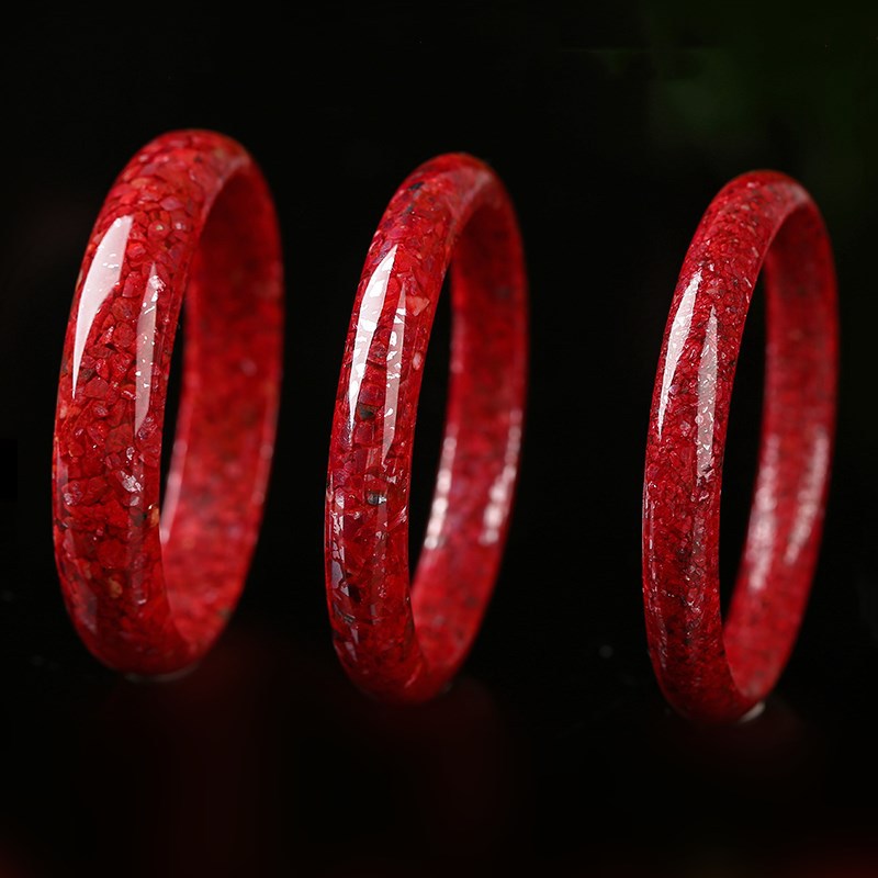Deep red mineral bangle with bright polished curved surface