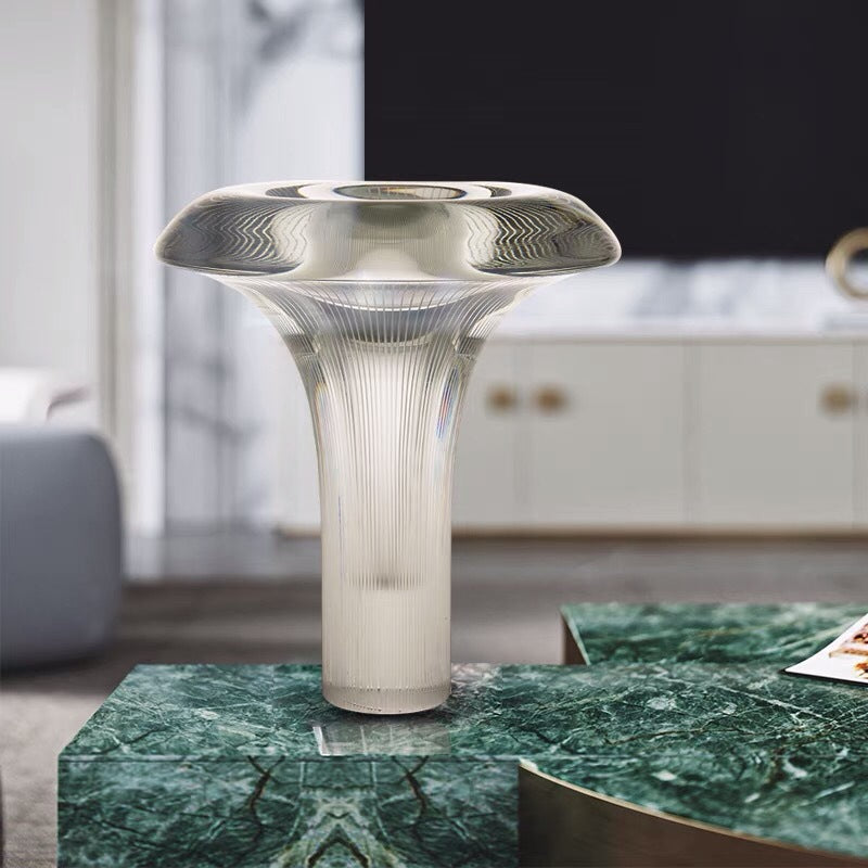 Clear glass ambient table lamp styled beside sofa