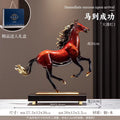 Red copper rearing horse sculpture on wooden base