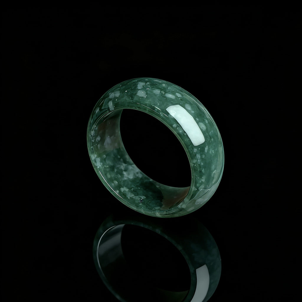 Dark emerald green jadeite statement ring on black reflective background