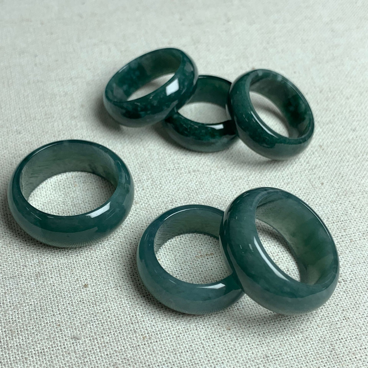 Deep green jadeite wide band ring assortment with smooth polished surfaces