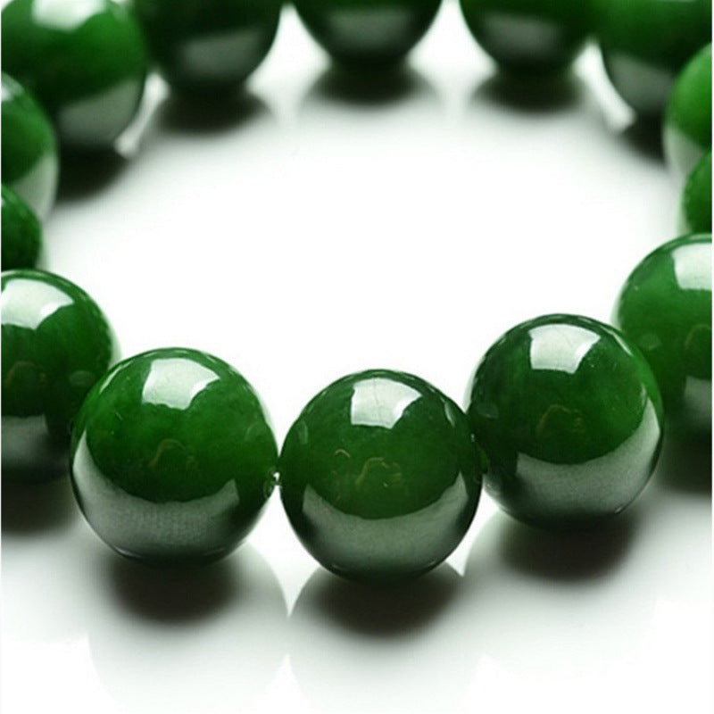 Close-up of glossy deep green round stone beads