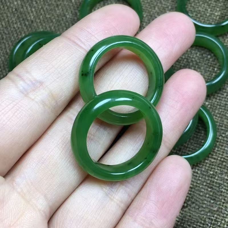 Pair of deep green polished stone rings with smooth rounded profile