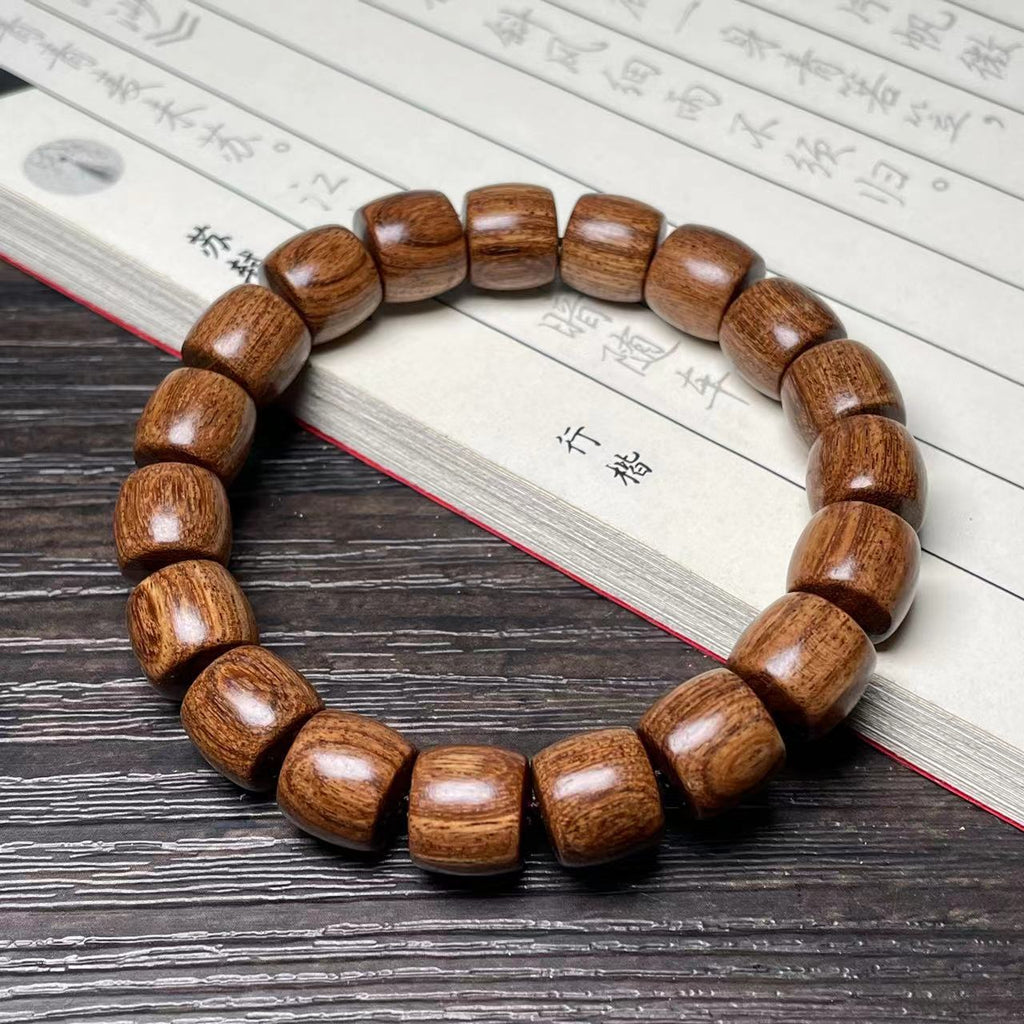 Brown-grain direct-cut old-shape wood barrel bead bracelet on Chinese book