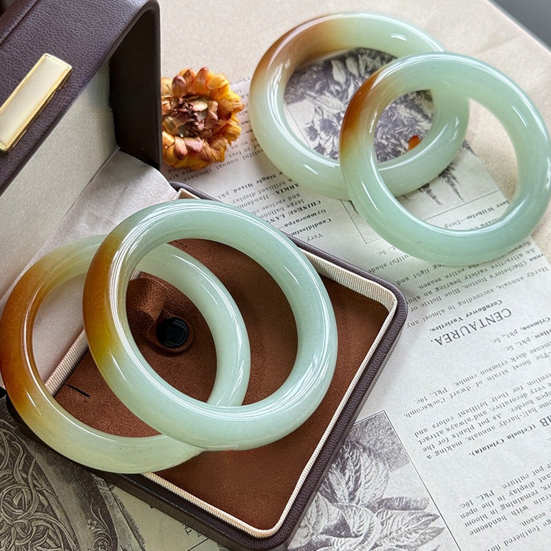 Dunhuang-style Dongling jade bangle showing green and golden mineral tones