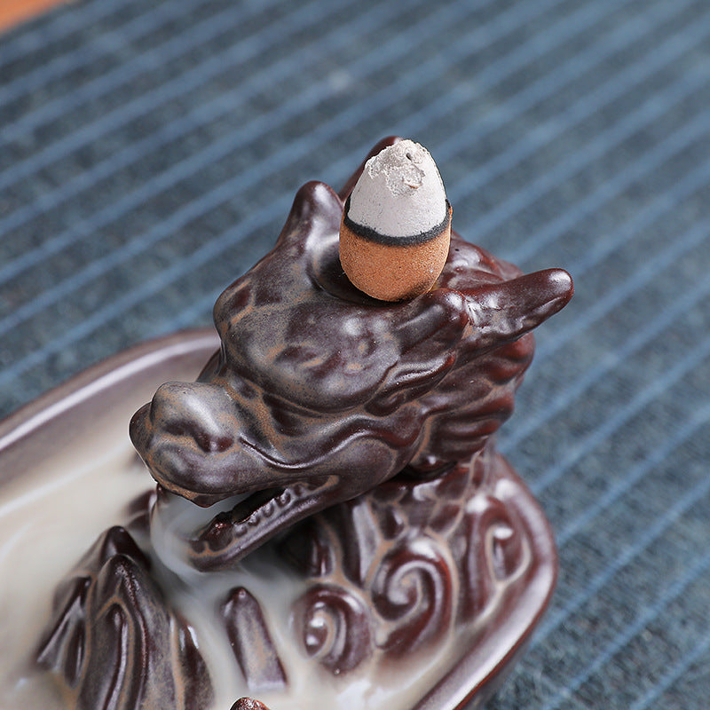Close-up of dragon head and backflow cone on Chinese landscape incense burner