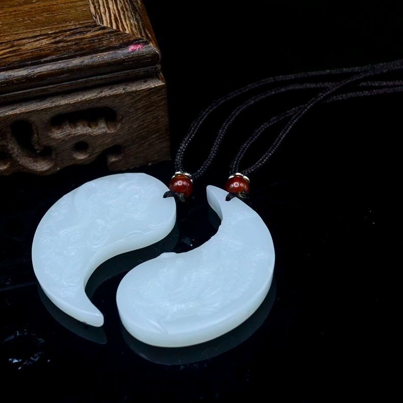 White dragon and phoenix couple pendants displayed together as matching set