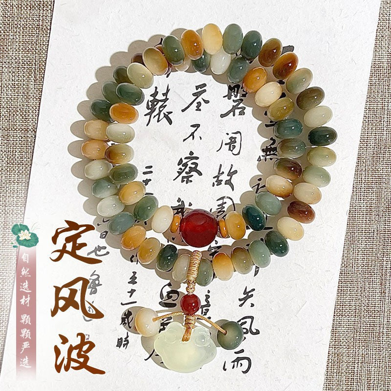 Dunhuang-inspired multicolor Bodhi root double-wrap bracelet with red focal bead and pale carved pendant