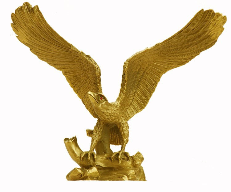 Golden eagle copper sculpture front view with wings raised on rocky base