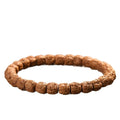 Five-claw Vajra Bodhi-style single-wrap bracelet with carved textured seed beads on white background