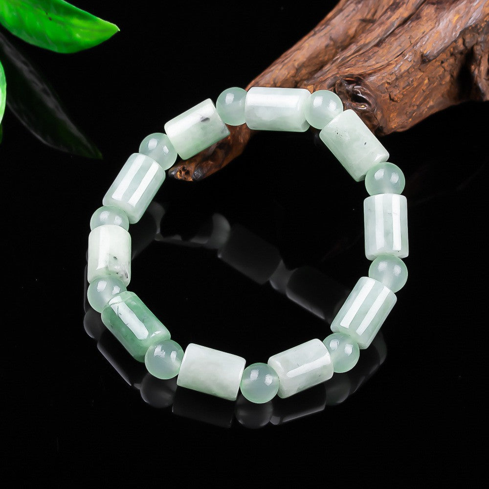 Certified jadeite barrel bead bracelet showing translucent white green body