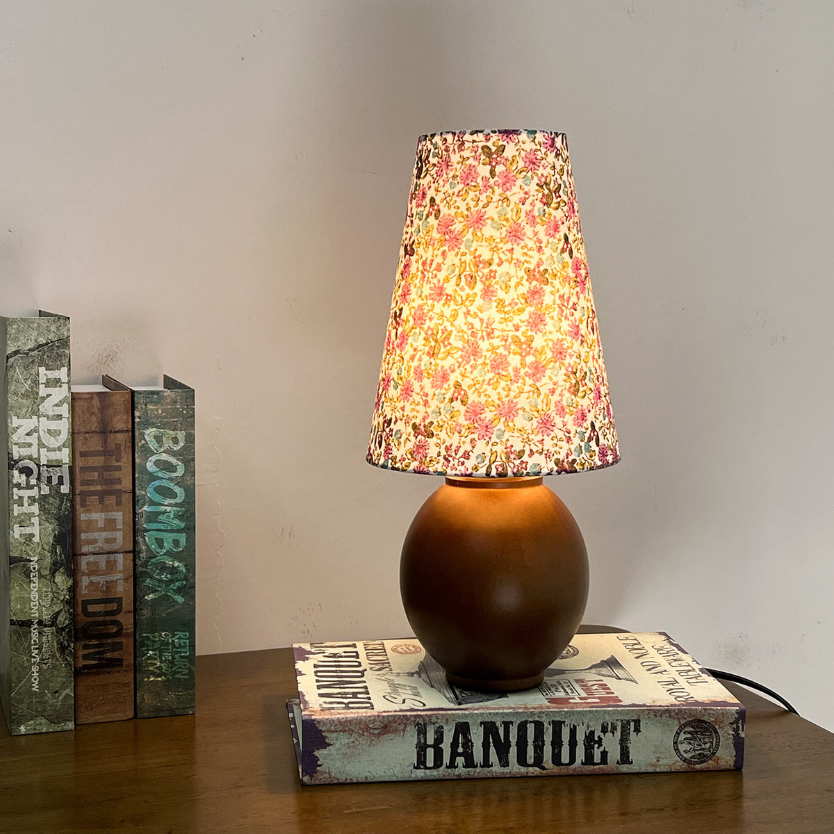 Warm glowing floral pleated table lamp with dark walnut wood sphere base