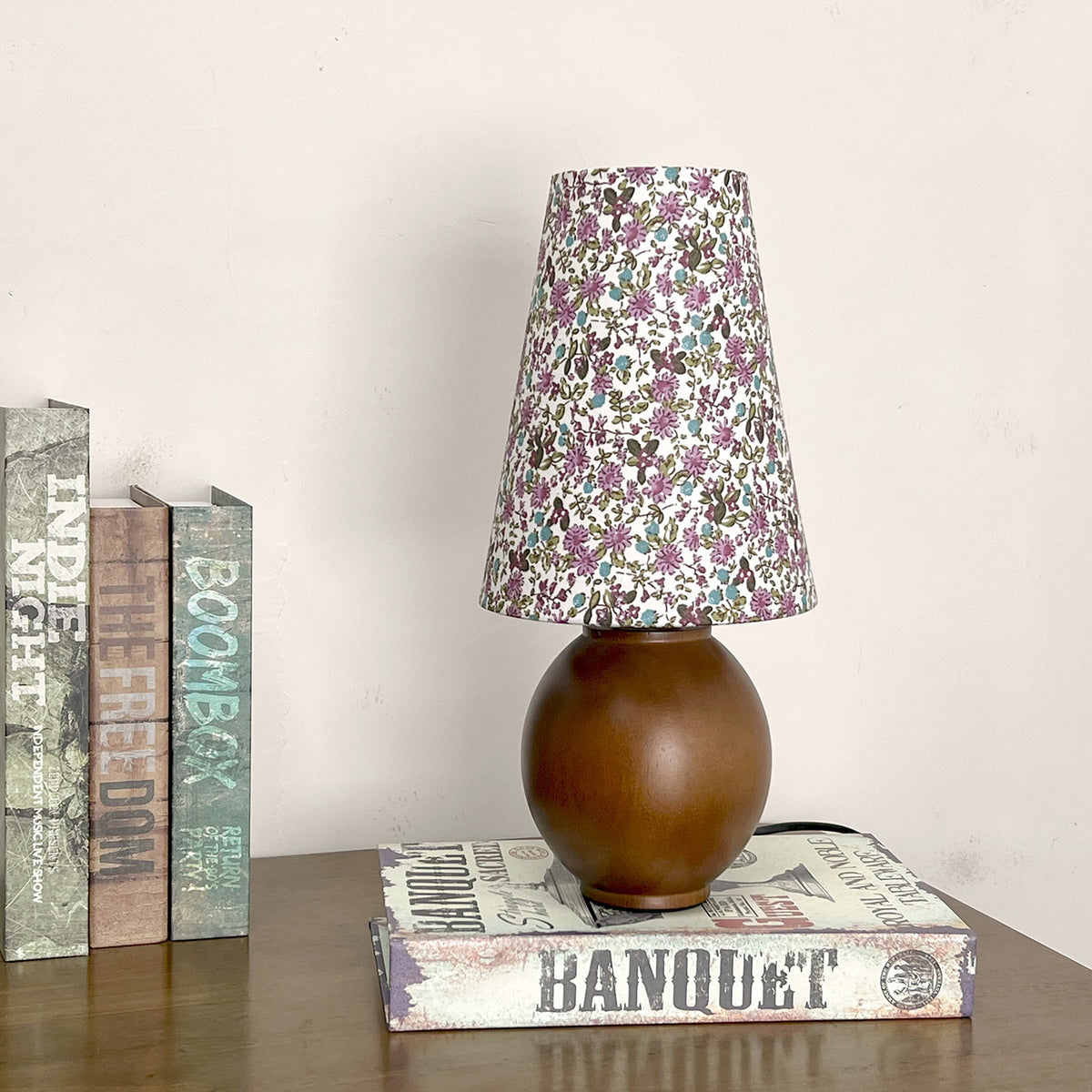 Walnut floral shade table lamp styled on books and console