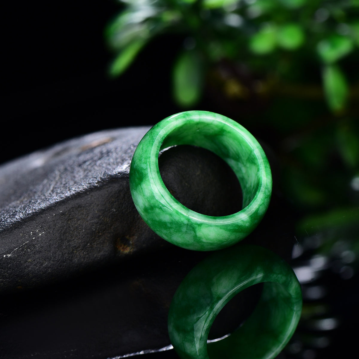 Vivid green jadeite ring band showing natural mottled colour pattern