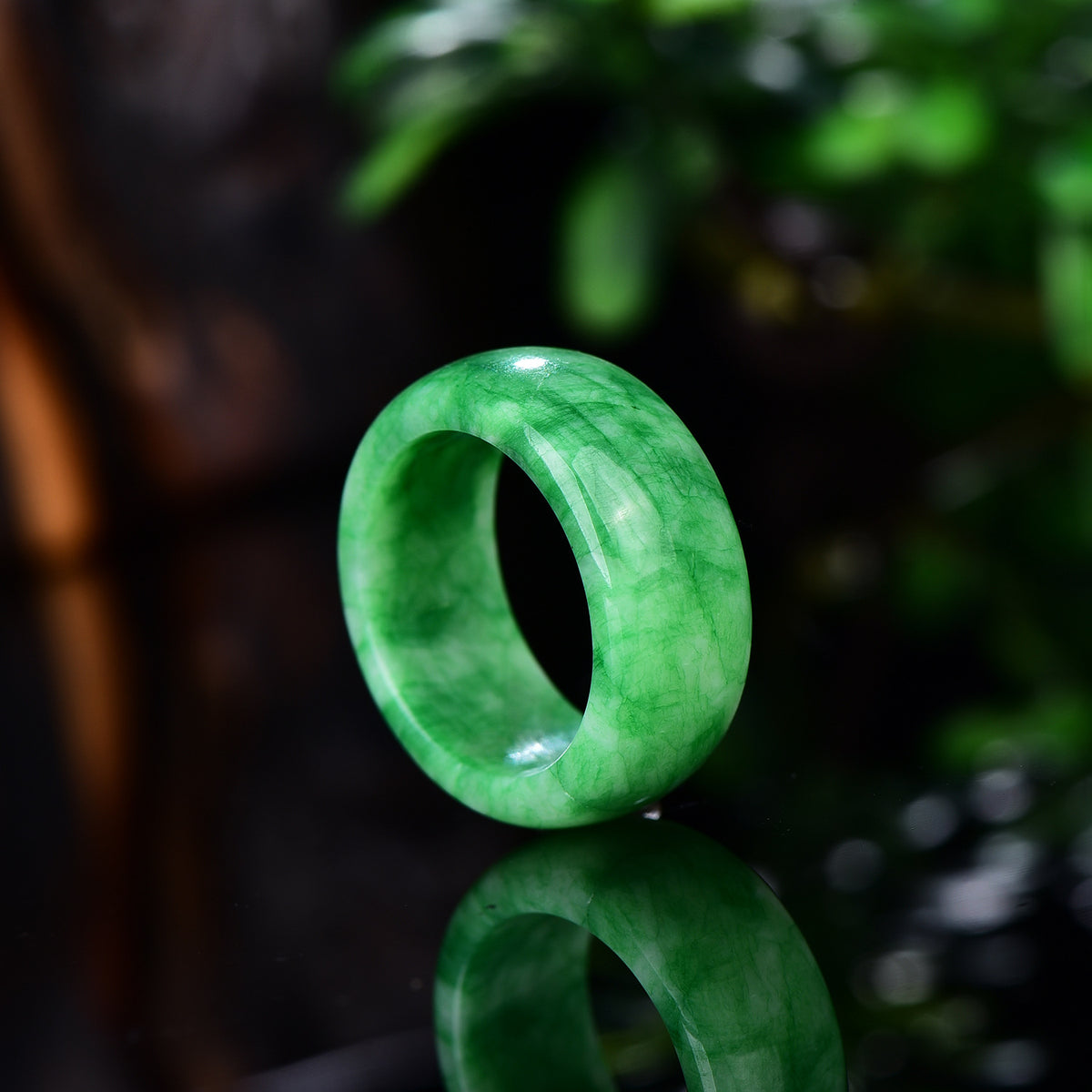 Certified green jadeite ring close-up showing high polish and stone texture