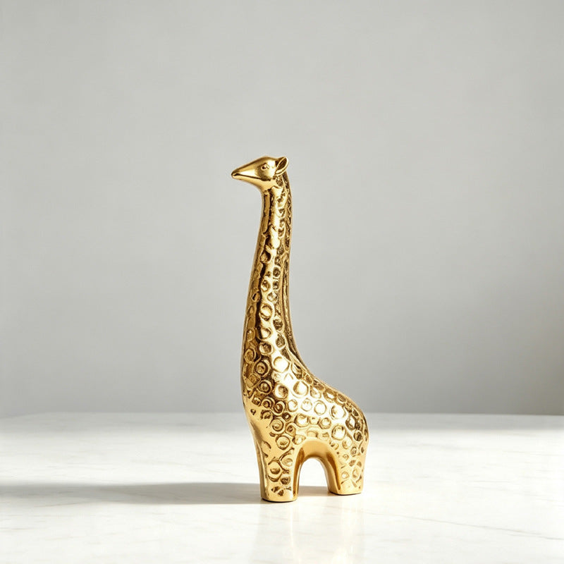Gold ceramic giraffe figurine with textured surface for console styling