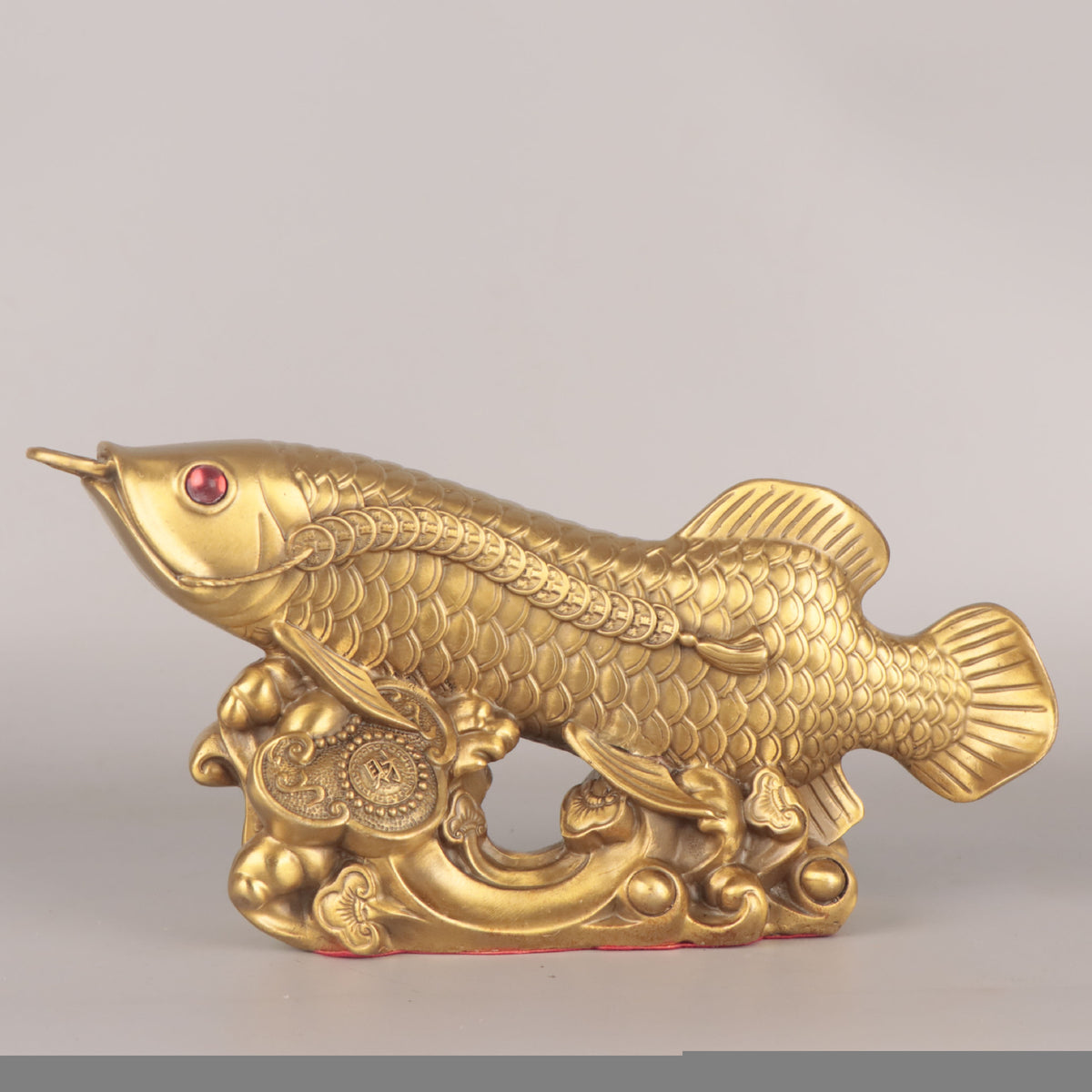 Golden arowana copper sculpture with coin and wave motifs for Chinese auspicious home decor