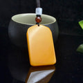 Golden yellow smooth Chinese peace plaque pendant front view