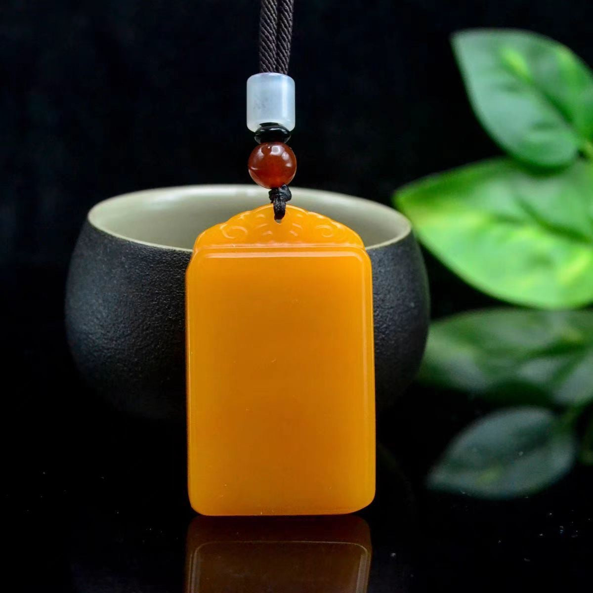 Polished golden yellow rectangular peace plaque pendant close view