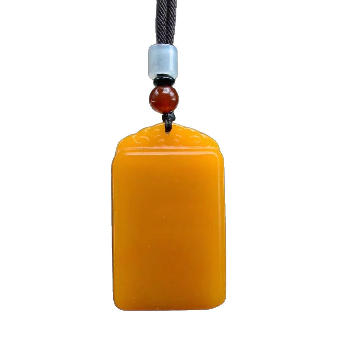 Golden yellow smooth plaque pendant isolated on white background