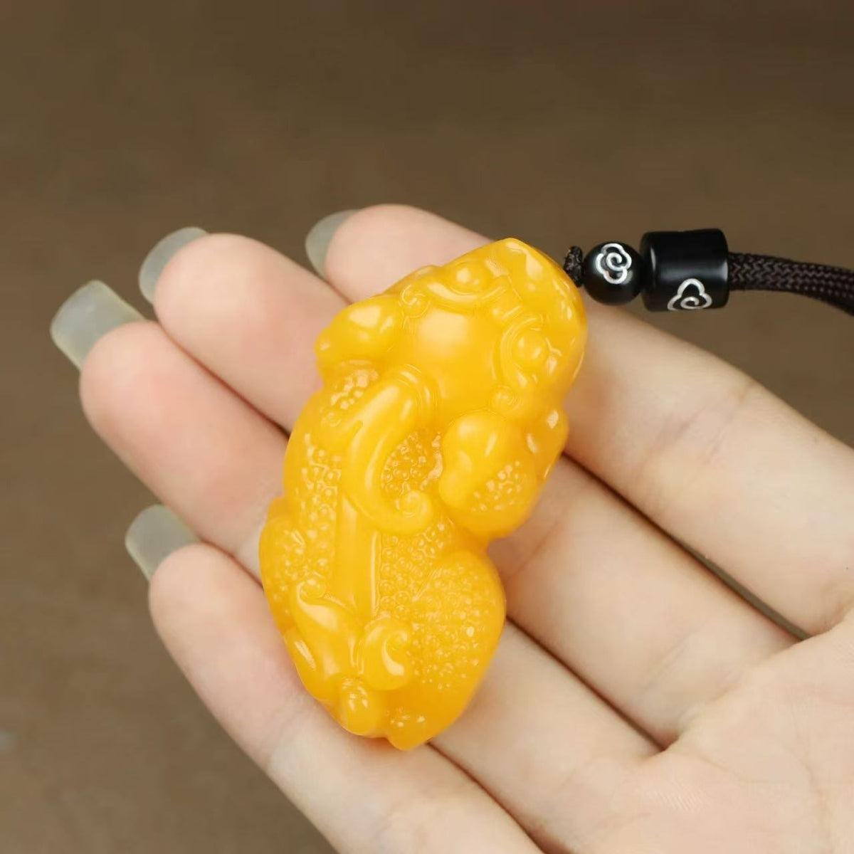 Polished golden Pixiu Chinese auspicious pendant close view