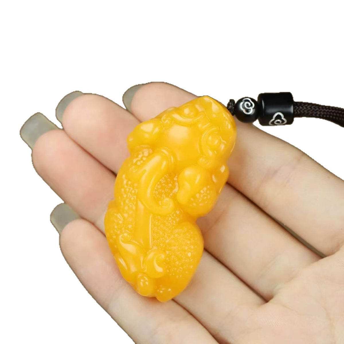 Golden yellow Pixiu pendant isolated on white background