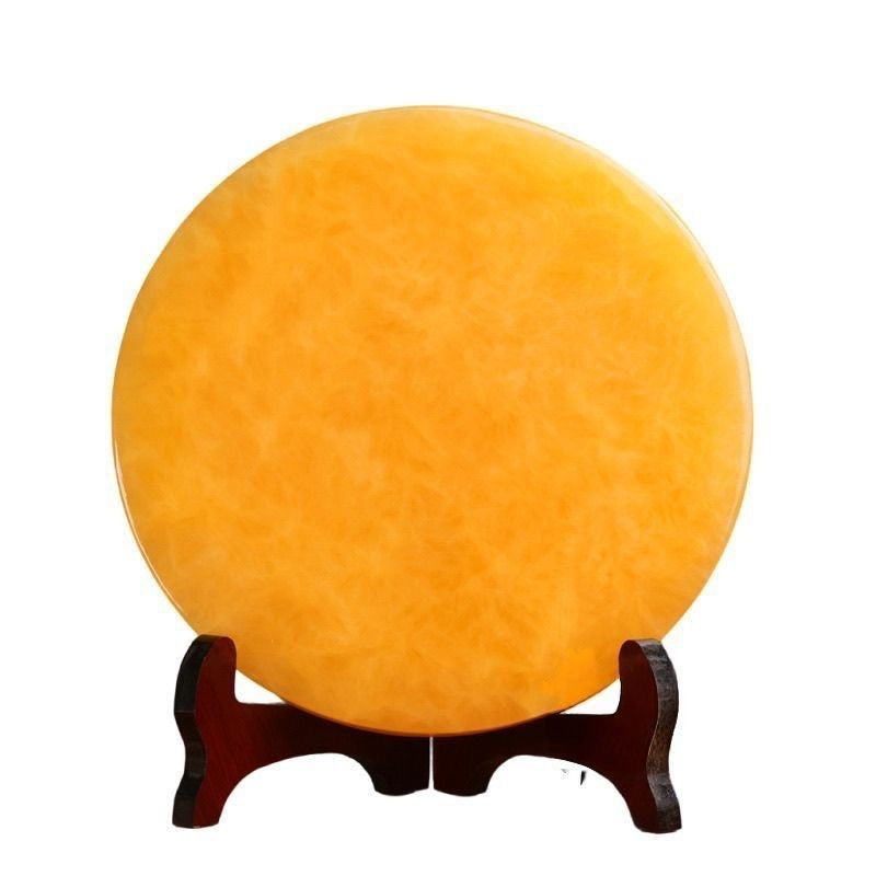 Golden yellow Chinese bi-disc style display ornament on dark wood stand