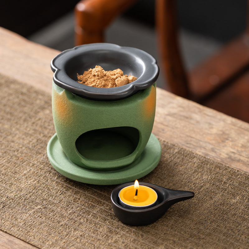 Green ceramic aromatherapy burner with black flower dish and candle holder