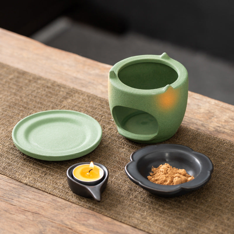 Green ceramic candle-heated incense powder warmer with removable dish and tea light