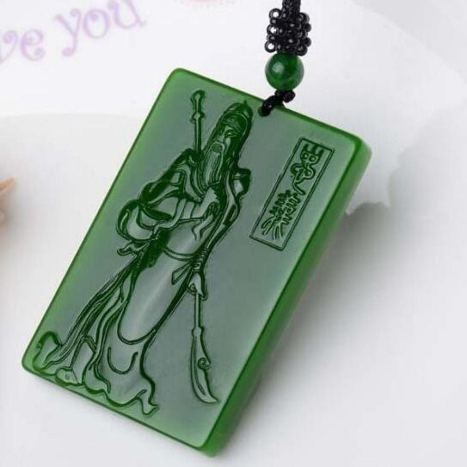 Green Guan Yu plaque pendant angled view with black braided necklace cord