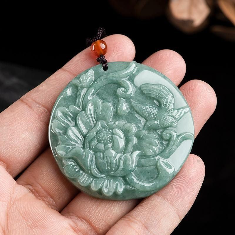 50 mm green carved round pendant held in hand for scale