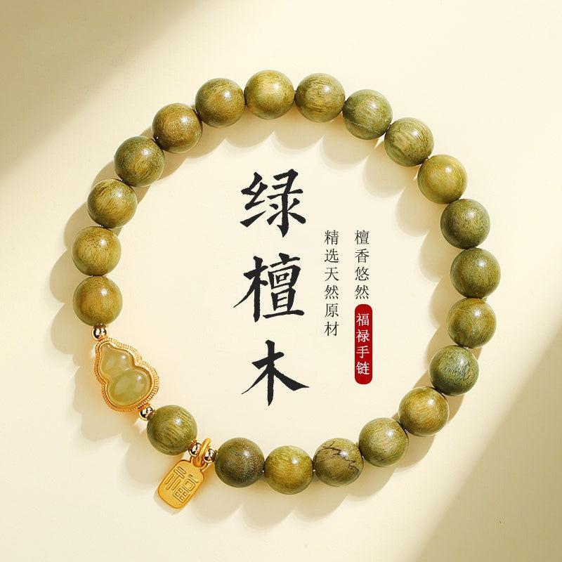 Green sandalwood-style 8mm bracelet with pale gourd-shaped focal piece and Fu charm