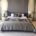 Pair of smoky green glass table lamps on bedroom nightstands