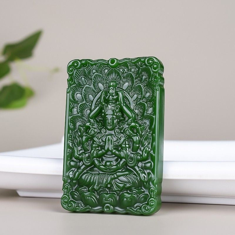 Deep green Guanyin relief pendant on neutral background