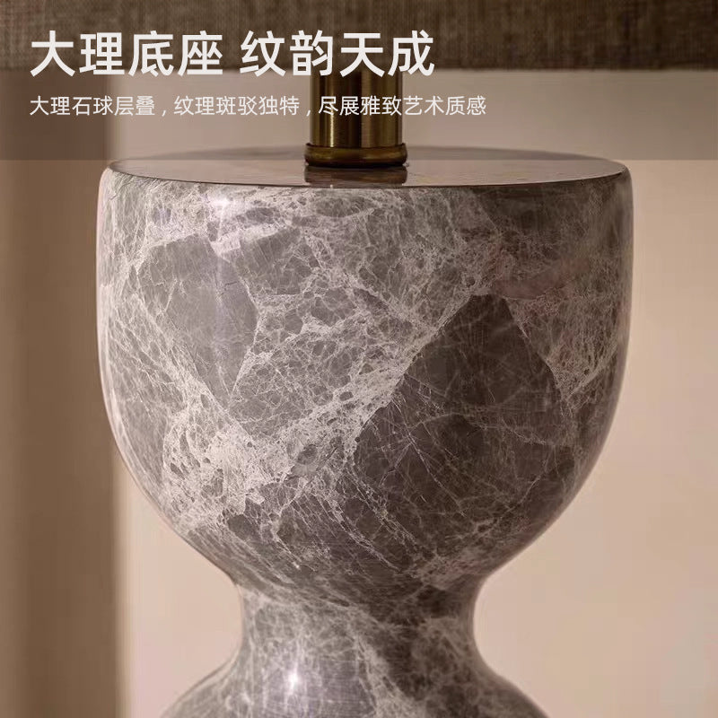 Close-up natural grey marble texture on sculptural hourglass lamp base