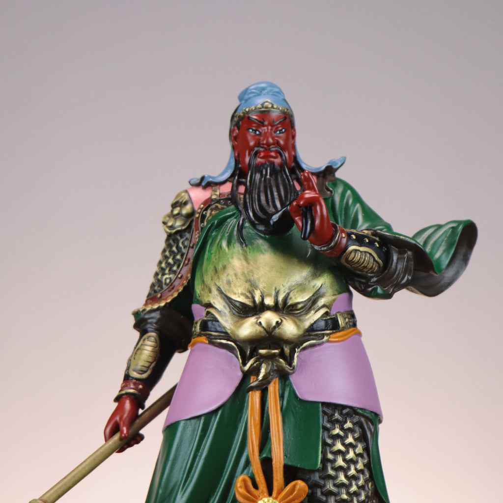 Close detail of painted Guan Yu Guan Gong copper sculpture face armor and robe