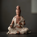 Seated Guanyin ceramic sculpture in warm terracotta and ivory robe
