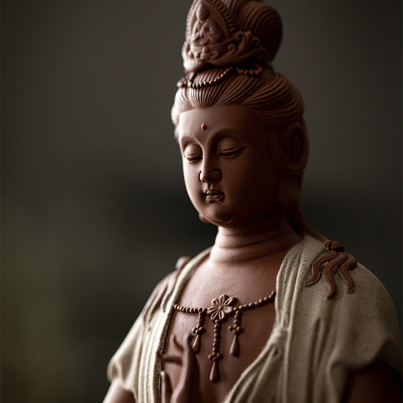 Close detail of serene Guanyin face and carved headdress