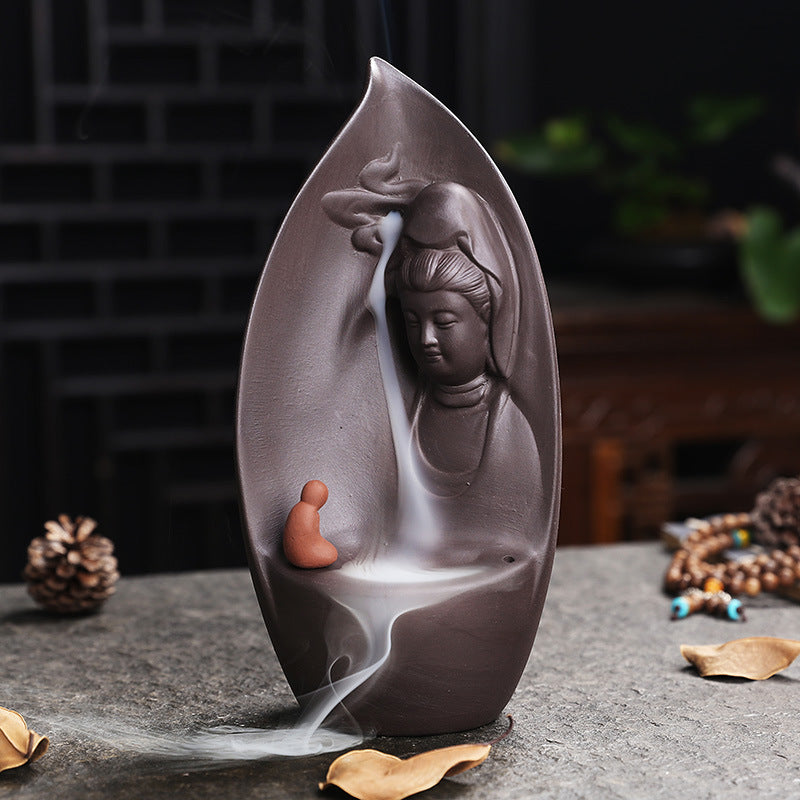 Guanyin Bodhisattva leaf incense burner displayed in a Chinese tea room setting