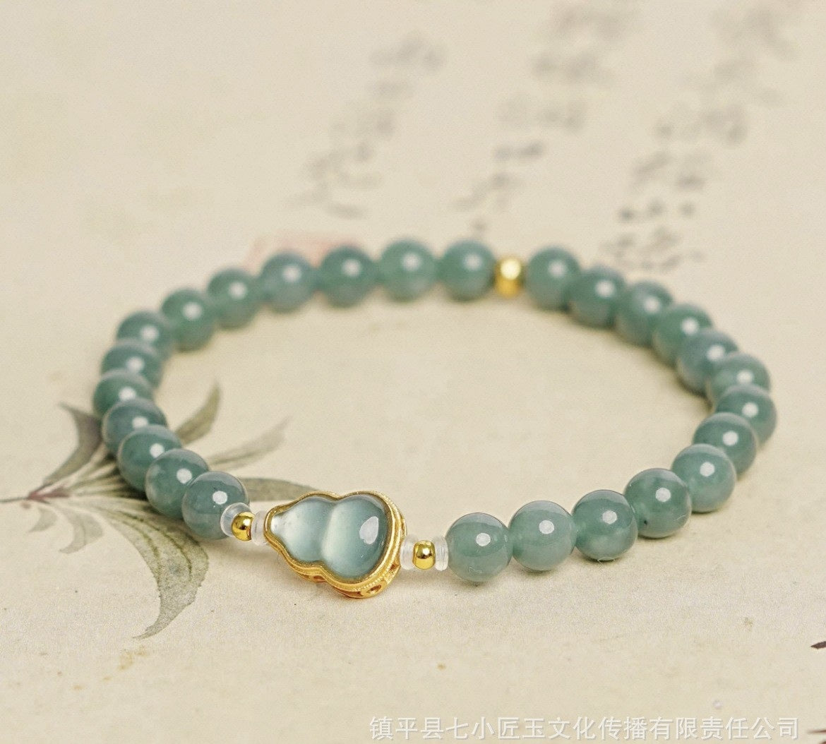 Guatemalan blue water jadeite bracelet with heart charm and gold tone detailing