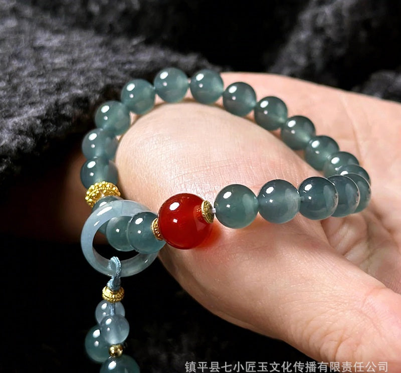 Blue water jadeite bead bracelet with red agate focal bead close up