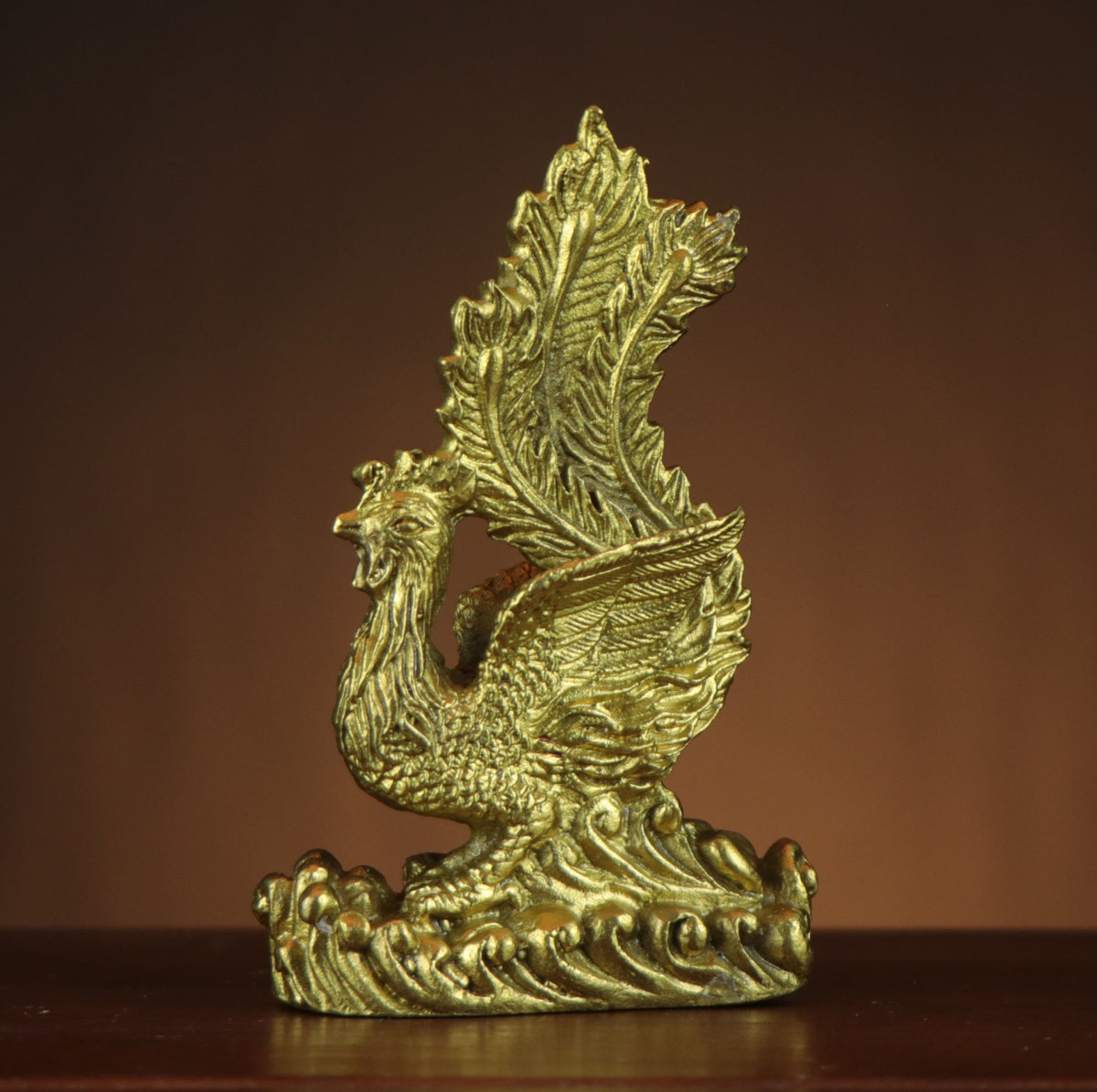 Chinese Han Phoenix Fenghuang copperware sculpture with raised wings and long tail feathers on a stylized wave base for study tea room and office decor