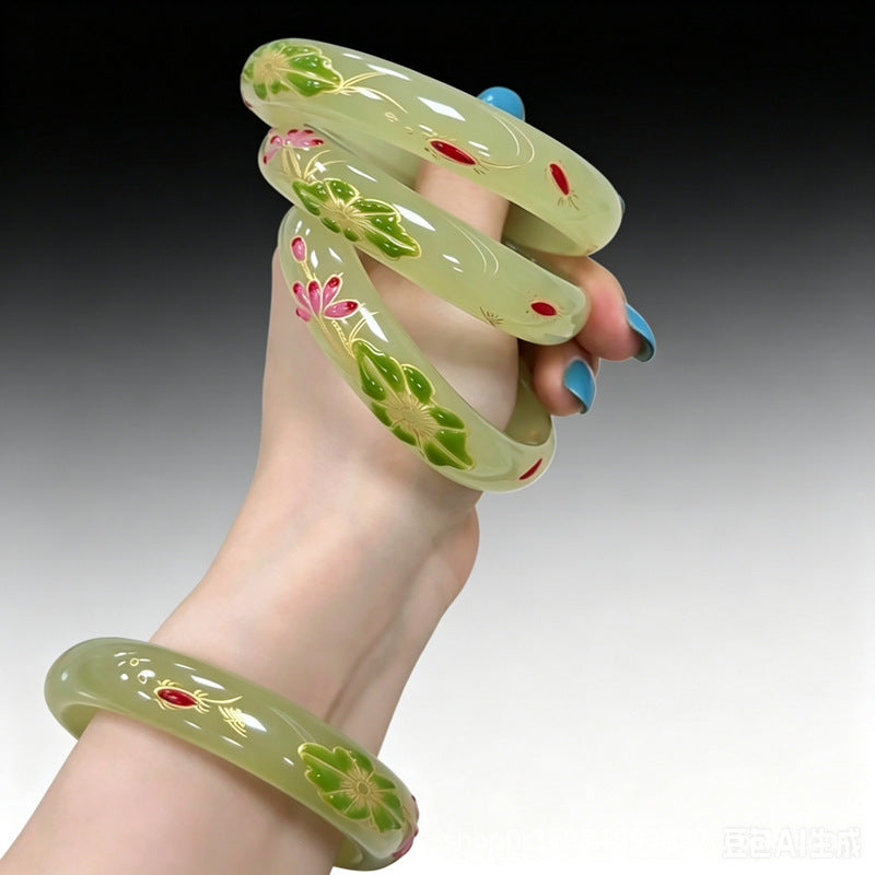 Polished floral bangle showing green lotus and gold outline detail