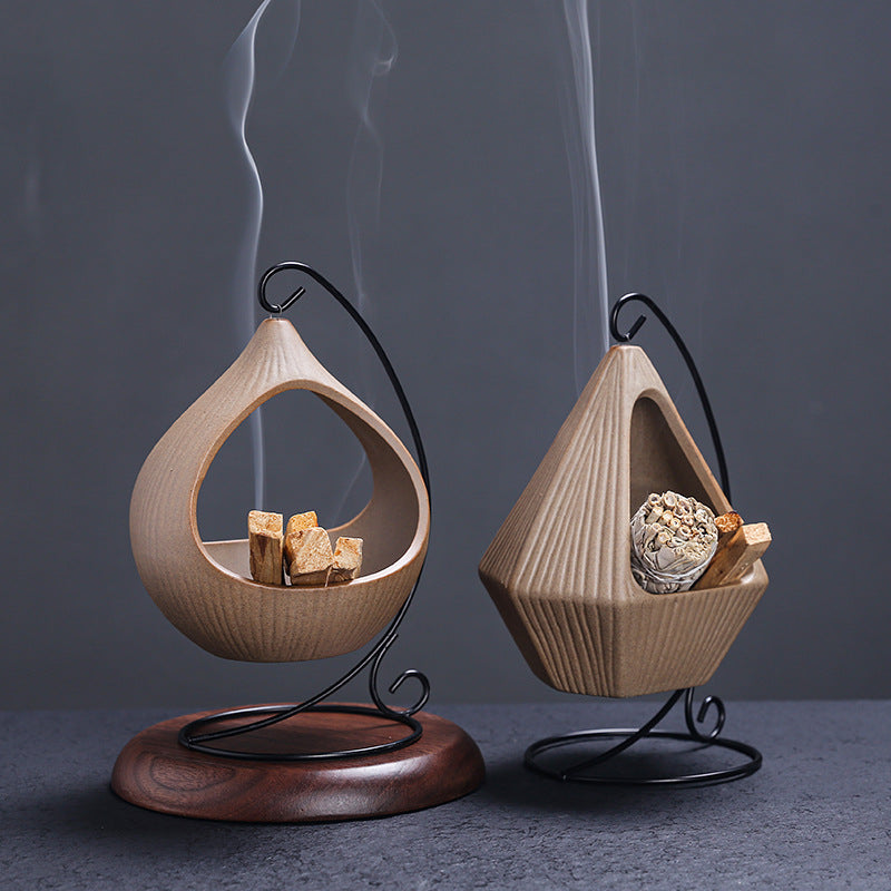 Hanging ceramic sage and Palo Santo holders on decorative metal stands