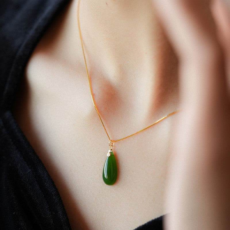 17 by 8 millimeter Hetian Biyu water drop pendant with gold detail