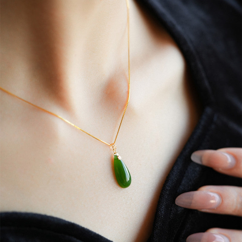 Minimalist green Hetian jade teardrop necklace worn on model
