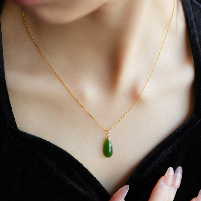 Certified Hetian Biyu teardrop pendant showing translucent green tone