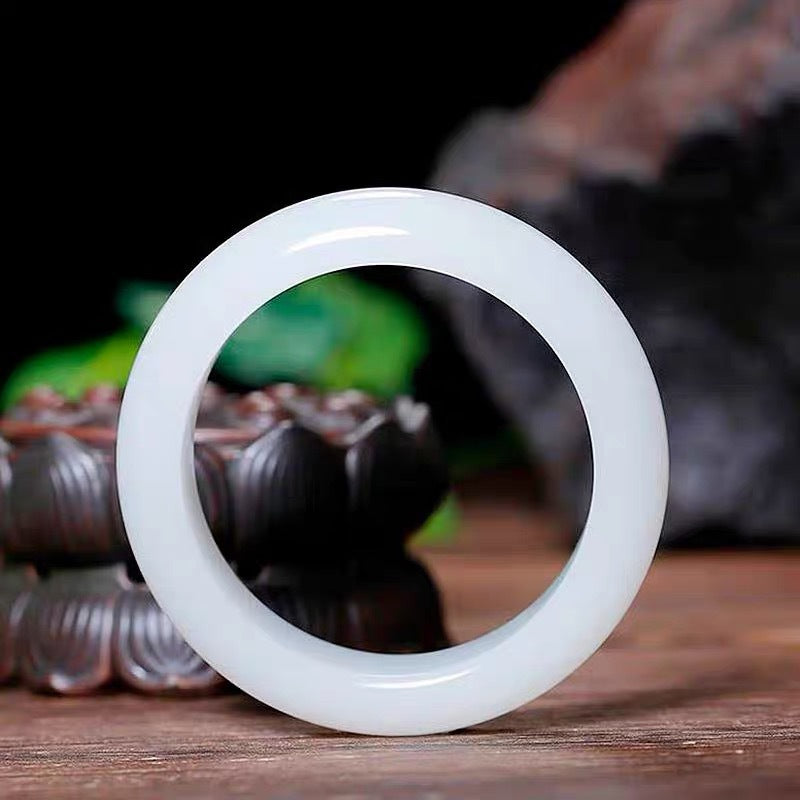 Certified natural Hetian white jade bangle on wood background