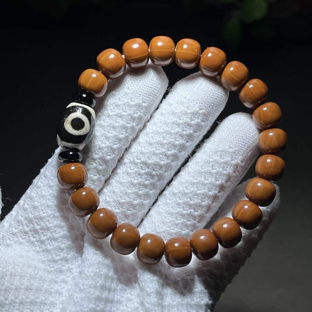 Houtou wenwan 8x9mm barrel bead bracelet with black and white three-eye Dzi-style patterned focal bead